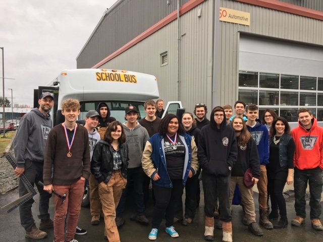 Jim Palm with a group of students outside an automotive training facility